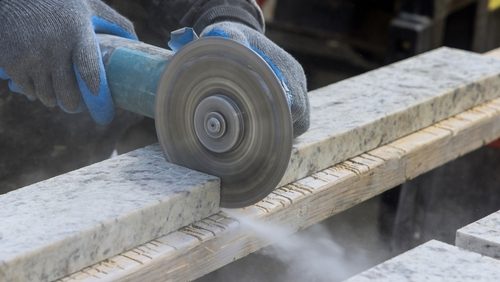 Dust,While,Grinding,Closeup,Of,Worker,Cutting,Granite,Plate,With