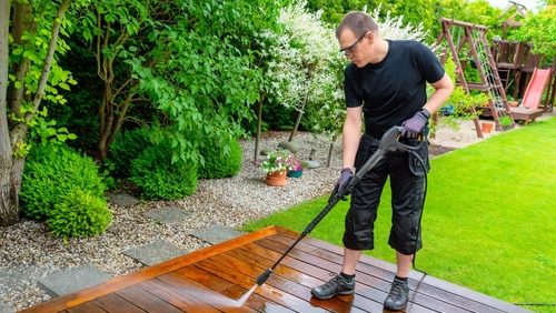 Man,Cleaning,Terrace,With,A,Power,Washer,-,High,Water
