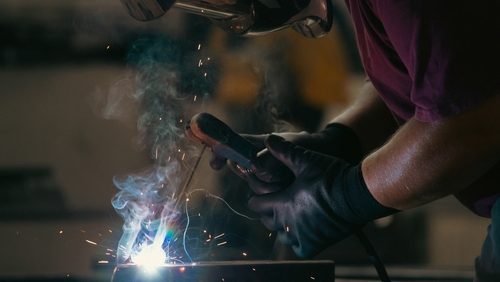 Handyman,Performing,Welding,And,Grinding,At,His,Workplace,In,The