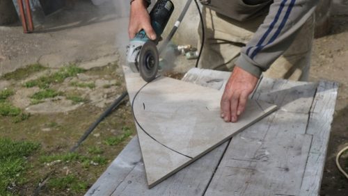 Cutting,Large,Ceramic,Tiles,With,A,Grinder,Along,A,Black
