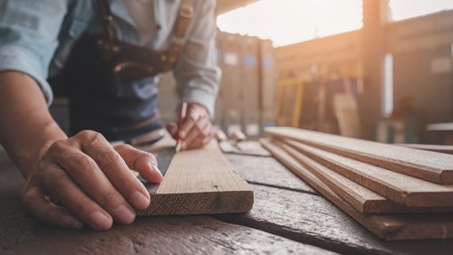 Carpenter,Working,With,Equipment,On,Wooden,Table,In,Carpentry,Shop.