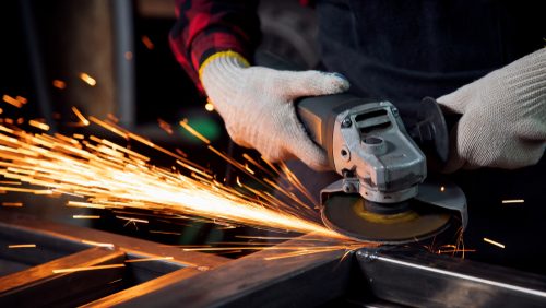 Worker,Hand,With,Electric,Wheel,Grinding,On,Steel,Structure,In
