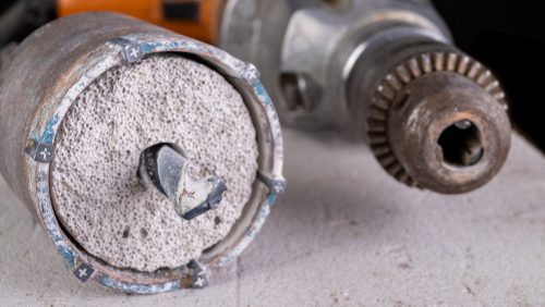 Drilling,Large,Diameter,Holes,In,Concrete,With,A,Hole,Saw.
