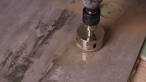 A,Builder,Cuts,A,Round,Hole,In,A,Porcelain,Tile