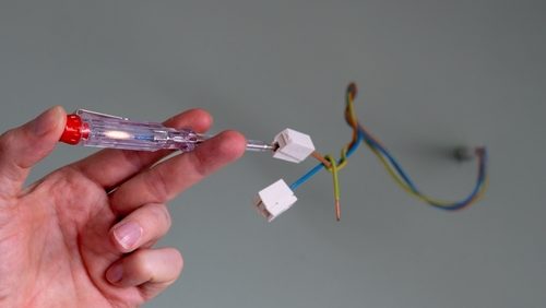 Person,Checks,With,An,Electrical,Line,Tester,The,Current,,Before